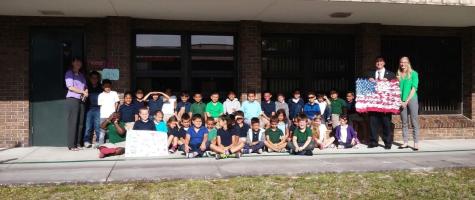 Closeup shot of a young man writing on a note pad
